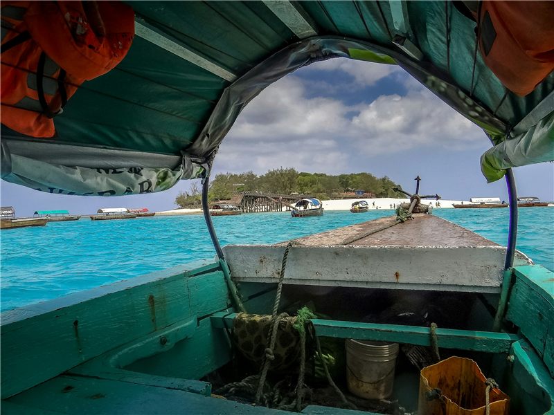 View from a boat across clear turquoise water.