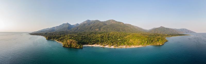 Forested mountain slopes descending to the blue waters of Lake Tanganyika.